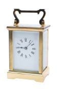 A modern brass carriage clock the eight-day duration timepiece movement having a platform lever
