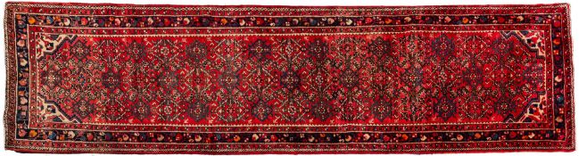 A Melayer runner, the rose field with an allover geometric lozenge design,