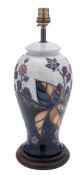 A John Moorcroft pottery lamp of baluster form tube lined after the original by Sally Tuffin