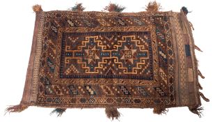 A Balouchistan grain bag, the brown field with twin stellar and hooked geometric medallions,