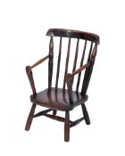 A Childs early 19th century rustic fruitwood elbow chair,