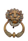A heavy brass lion's mask and ring door knocker,