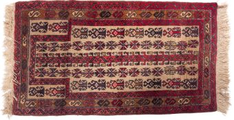 An Afghan Balouch prayer rug, the beige field with rows of hooked and serrated medallions,