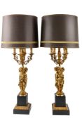 A pair of gilt metal and stone composition figural table lamps in Neoclassical taste,