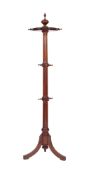 An Edwardian walnut circular revolving coat stand with urn finial and revolving top with fixed
