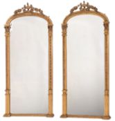 A pair of late Victorian giltwood and gesso domed pier mirrors,