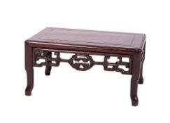A Chinese Huanghuali wood urn table with a rectangular banded top and pierced apron sides,