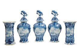 A Dutch Delft garniture comprising three jars and covers of flattened baluster form,