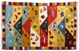 A Quashqai Kilim, the multicoloured striped field with a design incorporating animals,