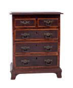 An apprenticeman's 19th century oak and rosewood chest, the top with a moulded edge,