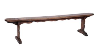 An early nineteenth century fruit wood trestle end bench,