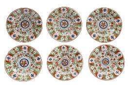 Six Dutch Delft plates, painted in iron red, green and blue with stylised blooms, 22cm diameter.