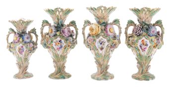 A garniture of three Coalport flower-encrusted vases and a matching smaller vase,