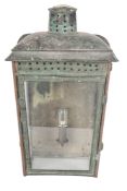 A late Victorian patinated metal and glazed wall lantern, circa 1900; of rectangular form,