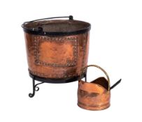A copper and iron bound circular log bin of large size with studded decoration,
