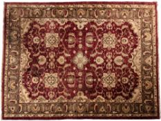 A Tabriz carpet, with wine field with an allover design of geometric medallions,