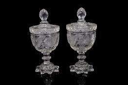 A pair of cut glass confitures and covers, set on an annular stem and domed petal shaped foot,