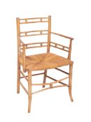 A Regency simulated bamboo elbow chair,