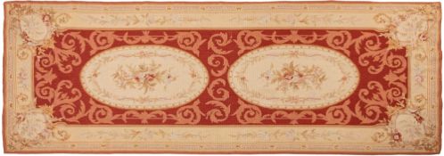 An Aubusson style needlework panel, in beige and rust colours,