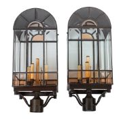 A pair of patinated metal and glazed ceiling lanterns,