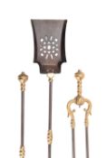 A set of Regency steel and brass fire irons, early 19th century; comprising shovel, poker and tongs,