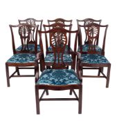 A set of seven George III mahogany dining chairs,