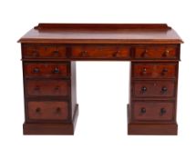 A Victorian mahogany pedestal desk, the rectangular moulded top with a ledge back,