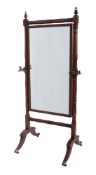 A Regency mahogany swing frame cheval mirror, the rectangular plate within turned surround,