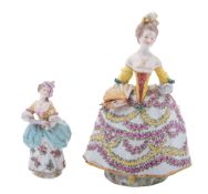 A French porcelain figure of an elegant lady in a floral dress holding a fan, 24cm high,
