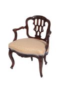 A mid 19th century carved walnut occasional elbow chair in the French taste,