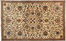 A Tabriz carpet, the ivory field with an all over design of palmettes and scrolling floral foliage,