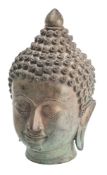 A Thai bronze Buddha head wearing a serene expression with curled hair and ushnisha,