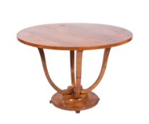 An Art Deco walnut circular dining table in the manner of Jules Leleu,