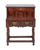 An 18th century oak coffer bach, with a detachable moulded top and triple fielded panel front,