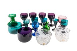 A mixed group of coloured glass comprising four matching and one similar amethyst glass rummers
