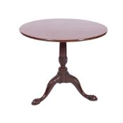 A George III mahogany circular tea table, with a snap top,