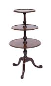 A George III mahogany circular three tier graduated dumb waiter,