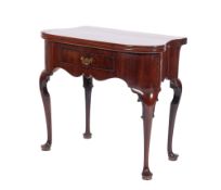 A George II 'red walnut' tea table, possibly Irish; of shaped outline, with a hinged top,