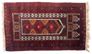 A Belouchistan prayer rug, the camel geometric mihrab with hooked and serrated designs,