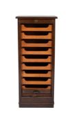 A 1920's walnut tambour fronted pedestal filing cabinet, fitted with sliding trays on a plinth base,