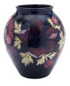A John Moorcroft pottery vase of oviform, tube lined in the Anemone pattern,