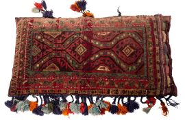 A Turkoman cushion, the indigo field with a design of hooked lozenge medallions,