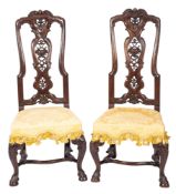 A pair of late George I or George II carved walnut side chairs,