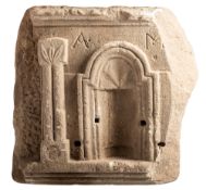 A carved limestone relief, possibly a shrine,