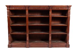 An Edwardian carved mahogany breakfront low open bookcase,