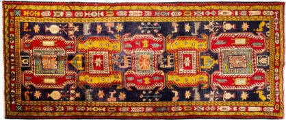 An Ardebil Kelle, the indigo field with a row of five hooked and shaped geometric medallions,