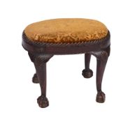 A carved beechwood oval stool in the George II taste the upholstered slip in seat within gadrooned