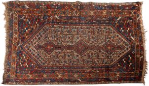 A Shiraz rug, the ivory hexagonal serated field with triple indigo,