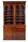 An early 19th Century mahogany bookcase, the upper part with a moulded cornice,