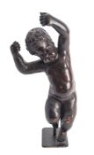 A Continental carved and stained wood model of a putto,